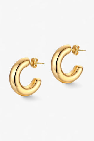 Gold hoop earrings on a white background