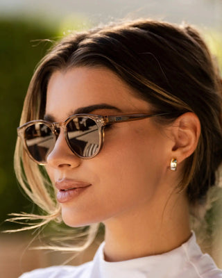 Woman wearing sunglasses with a blurred natural background