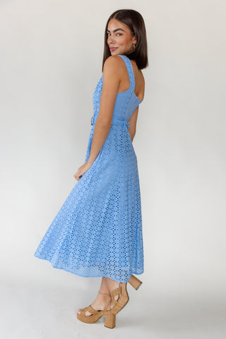 Side view of women's Positano French blue cotton eyelet midi dress showing belted waist, side pocket and full midi length