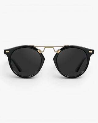 Black sunglasses with gold frames on a white background
