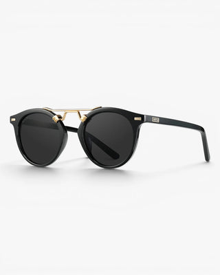 Black sunglasses with gold accents on a white background
