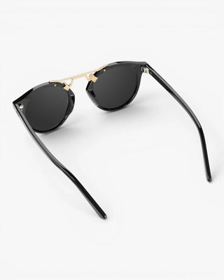 Sunglasses with tortoiseshell frame and dark lenses on a white background
