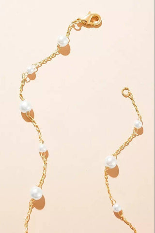 JO+CO delicate gold chain choker with small white acrylic pearls, adjustable length.